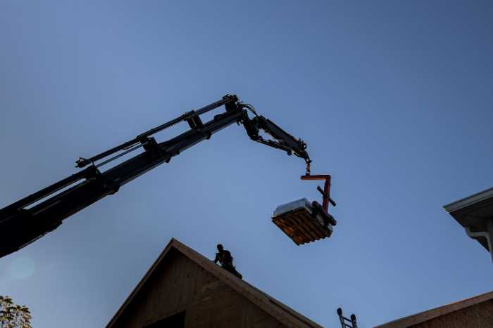 roofers begin work by delivering materials